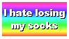 ID: Web stamp with a rainbow gradient background that says "I hate losing my socks." End ID.